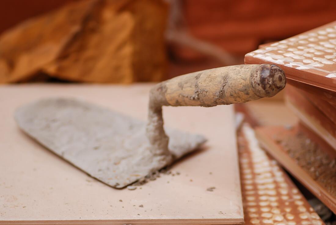 A concrete spade used for smoothing concrete surfaces prior to applying concrete stamps during the application of stamped concrete